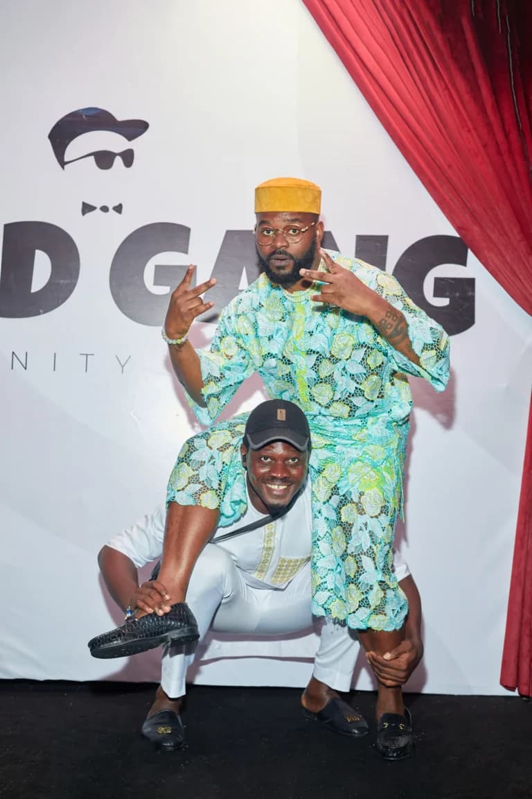 Falz and a guest posing at the Owambe Edition photo backdrop